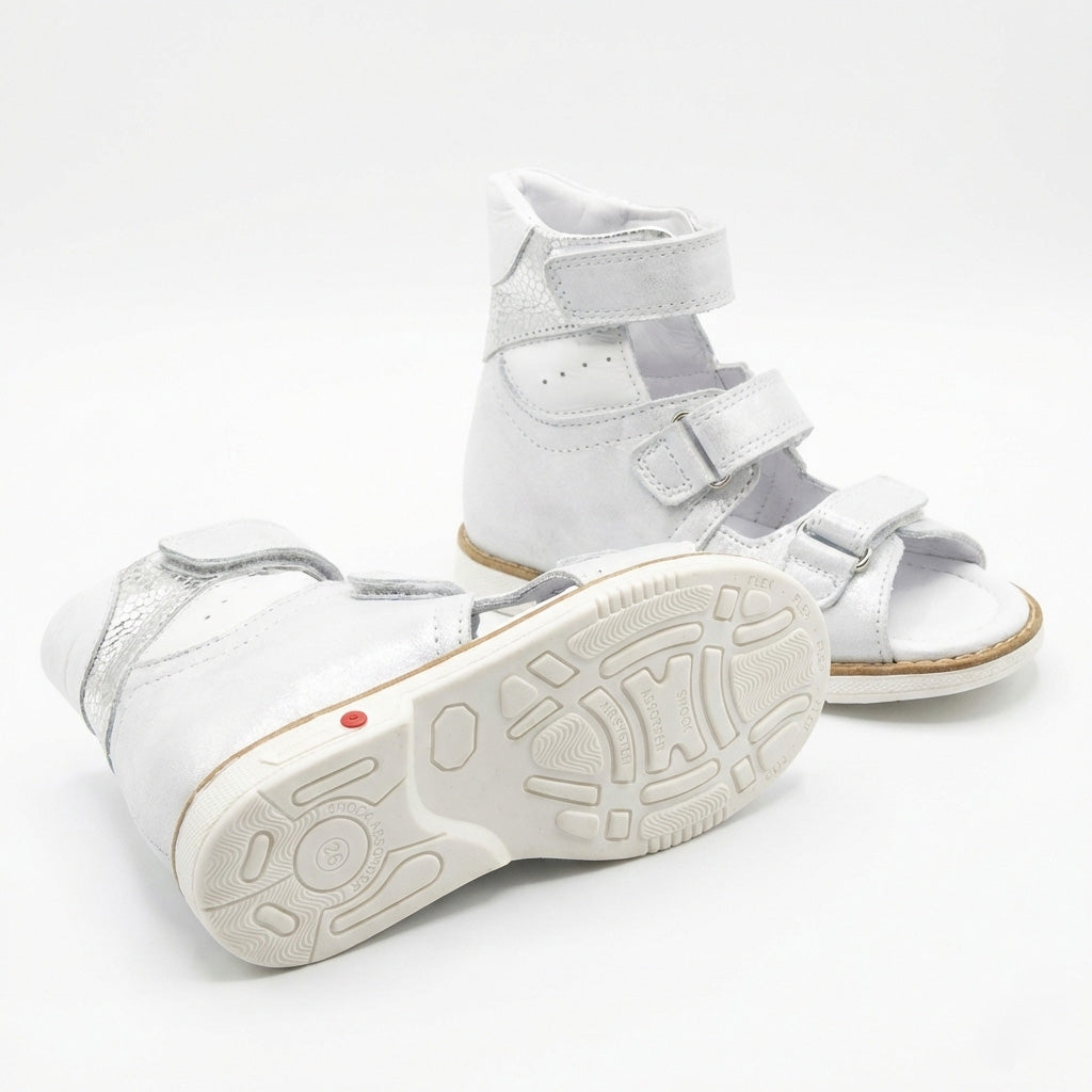 Kids’ white orthopedic sandals high‑ankle with multiple Velcro straps, ankle support, and cushioned sole for arch support, Thomas heels by Ortho Shoes.