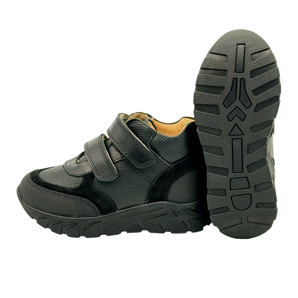 A side view of plain black orthopedic sneakers for kids with arch and enhanced ankle support. These sneakers feature a sleek and stylish design, making them suitable for school dress codes. The enhanced ankle support and arch support provide optimal stability and comfort for growing feet. The side view showcases the sneakers' construction and supportive features, ensuring the well-being of active kids throughout the day.
