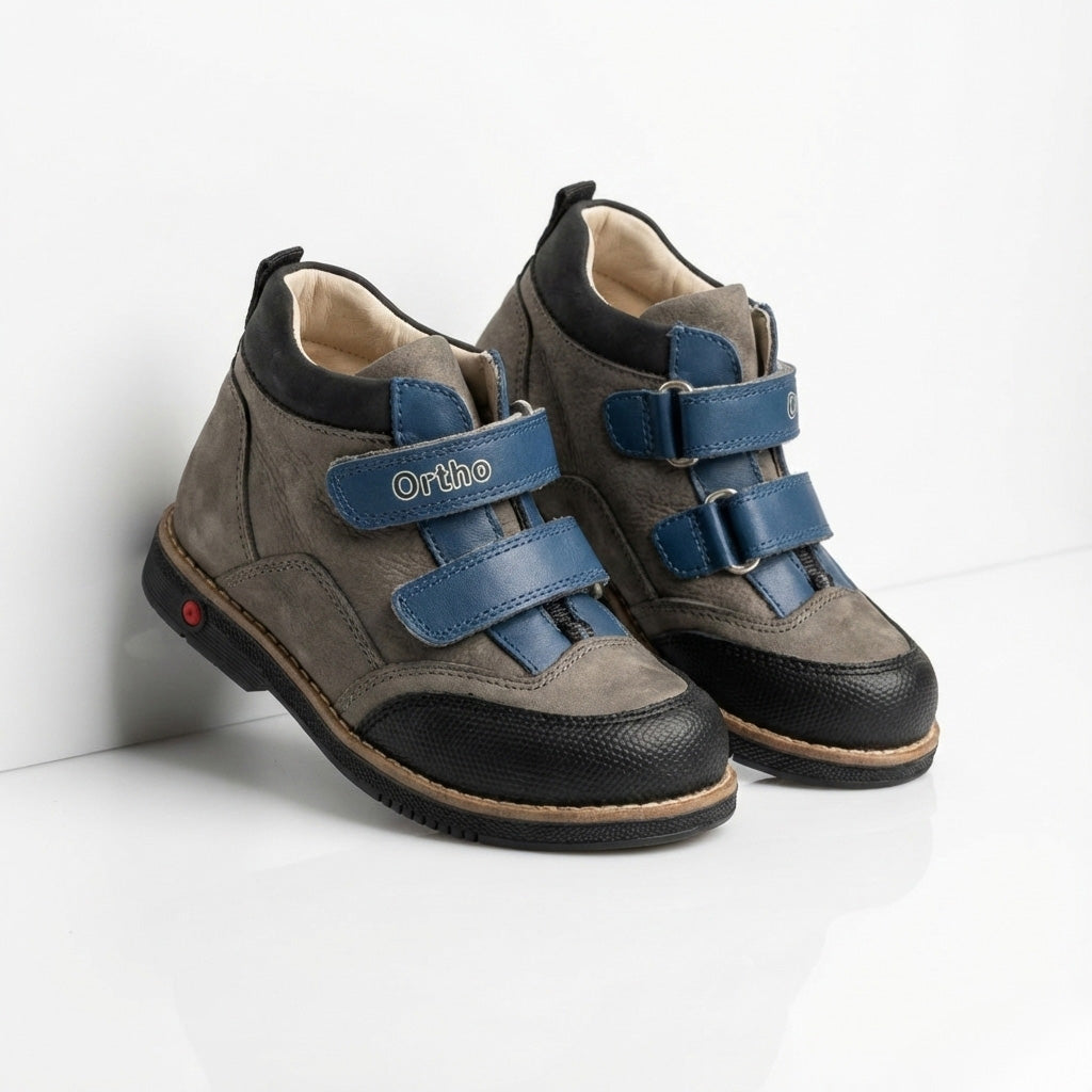 Children’s orthopedic shoes with Velcro closure, arch and ankle support, Thomas heels, and shock-absorbing sole by Ortho Shoes.
