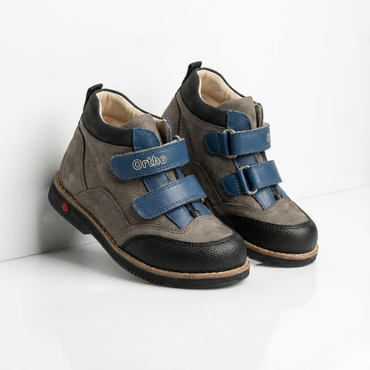 Children’s orthopedic shoes with Velcro closure, arch and ankle support, Thomas heels, and shock-absorbing sole by Ortho Shoes.