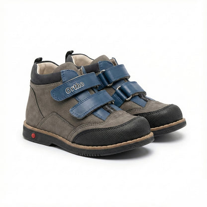 Children’s orthopedic shoes with Velcro straps, arch and ankle support, Thomas heels, and shock-absorbing sole by Ortho Shoes.