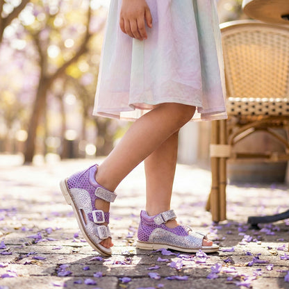 Girls’ orthopedic sandals with arch and ankle support, Thomas heels, and multi-strap design in purple and silver by Ortho Shoes.