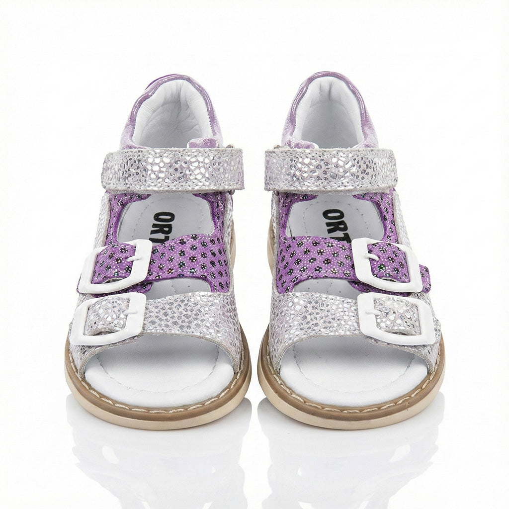 Supportive girls’ orthopedic sandals with glitter floral design, white buckles, arch support, and Thomas heels by Ortho Shoes.