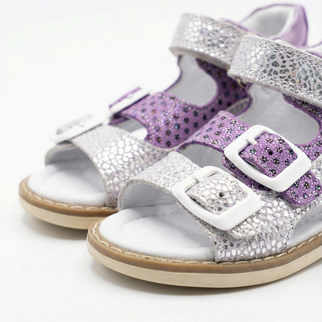 Supportive girls’ orthopedic sandals with glitter floral design, white buckles, arch support, and Thomas heels.