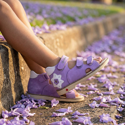 Supportive girls’ orthopedic sandals in purple with Velcro straps, ankle and arch support, and Thomas heels by Ortho Shoes.