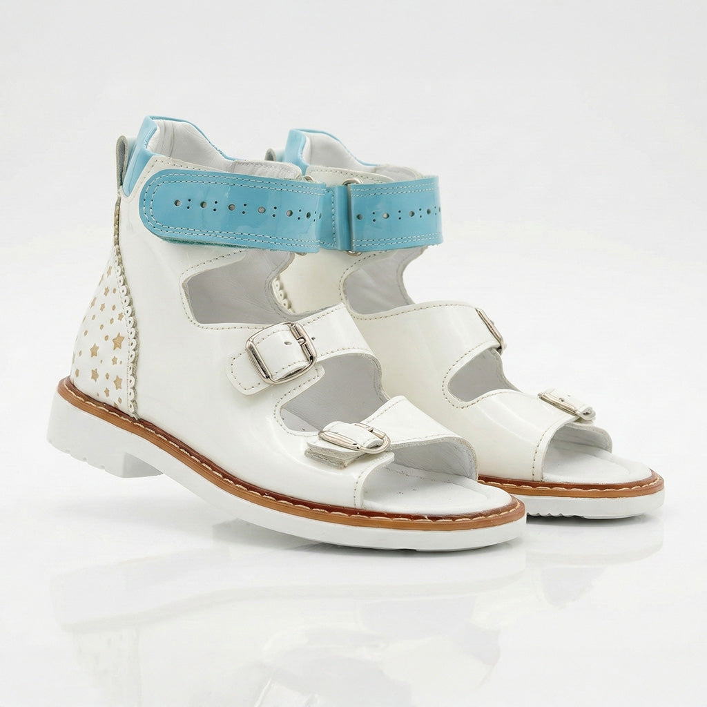 Ortho Shoes white orthopedic sandals for kids with blue perforated ankle straps, gold stars, and Thomas heels.