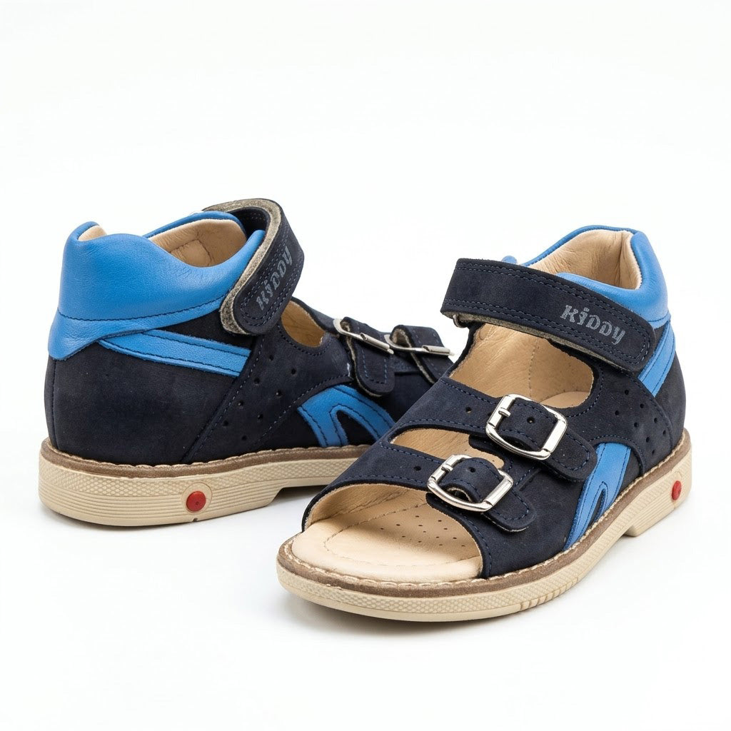 Mid-top orthopaedic sandals in navy nubuck and bright blue leather with structured cream sole and built-in Thomas heel.