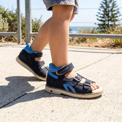 Boys navy blue orthopaedic mid-top sandals with arch support, Thomas heel, dual buckle straps, and top hook-and-loop strap.
