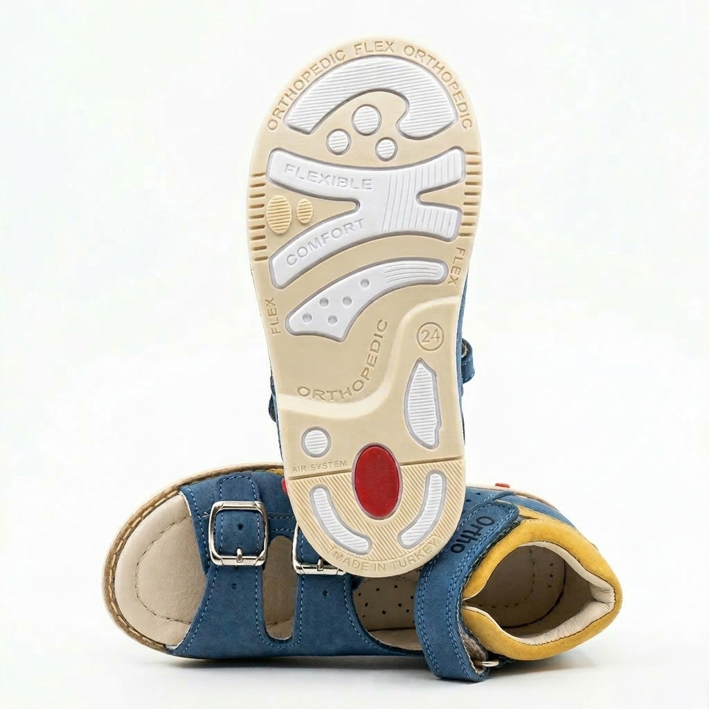 Children’s dark grey orthopedic sandals with yellow accents, multi‑strap, arch and ankle support, and rugged sole with Thomas heels by Ortho Shoes.
