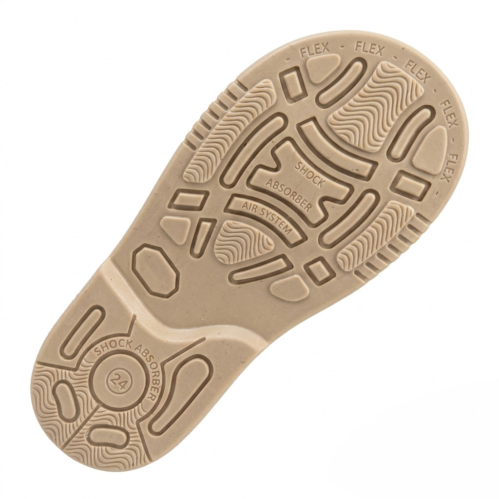 Underneath view of a cream kids shoe sole highlighting impact absorption grips and the Air System tread.