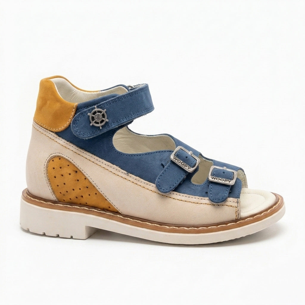 Mid-top orthopaedic sandals showing a cream sole, sturdy traction pattern, Thomas heel, three straps and a tiny silver helm charm.
