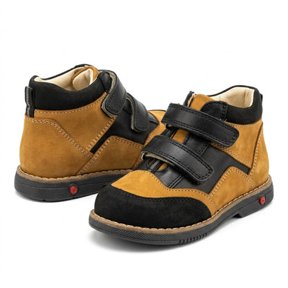 Side view of boys' nubuck and leather orthopaedic boots featuring double Velcro straps and supportive Thomas heels.
