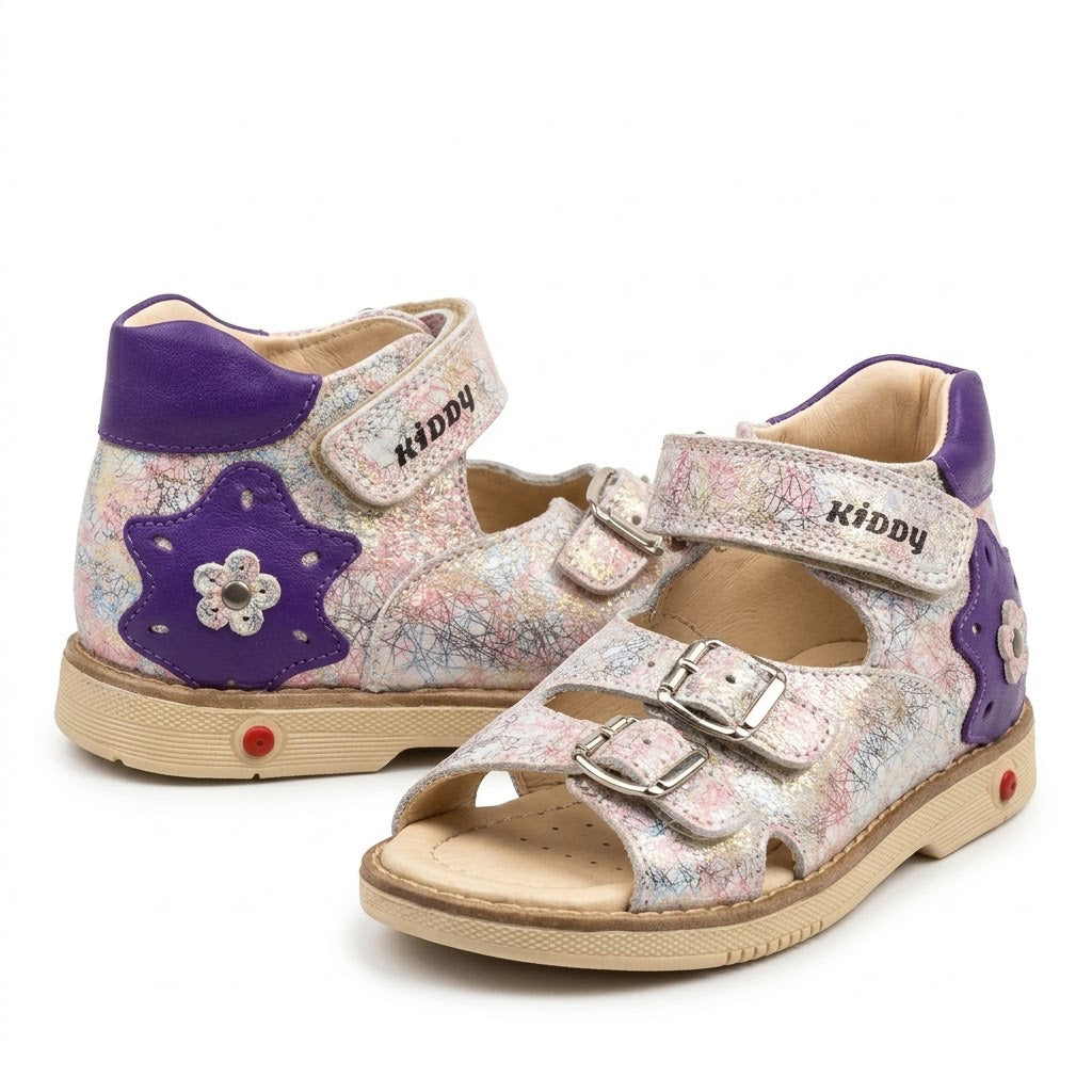 Side view of mid-top orthopaedic sandals showing purple star detail, Velcro strap, and sturdy beige sole.