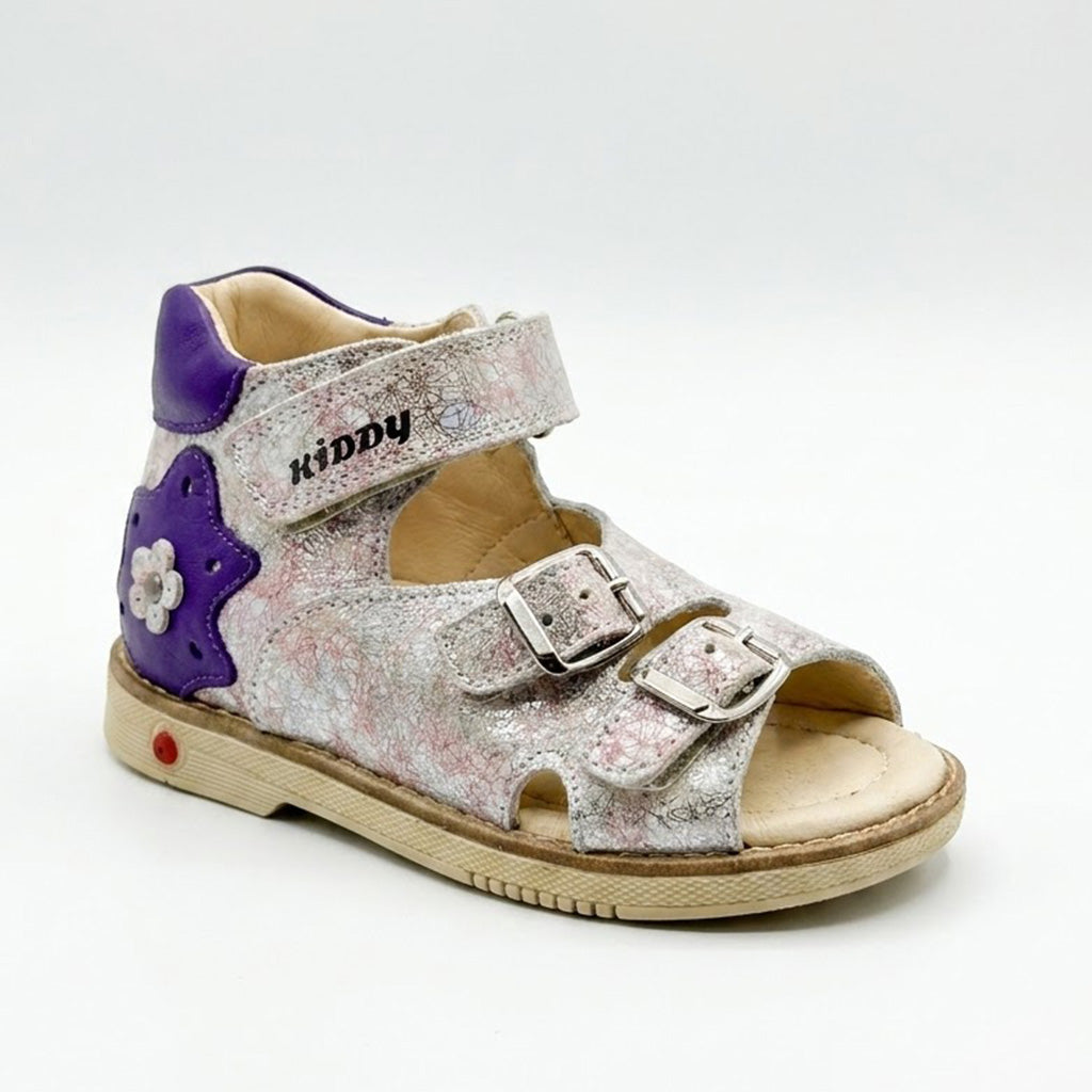 Side view of mid-top orthopaedic sandals showing purple star detail, Velcro strap, and sturdy beige sole.