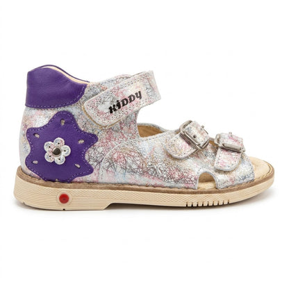 Side view of mid-top orthopaedic sandals showing purple star detail, Velcro strap, and sturdy beige sole.