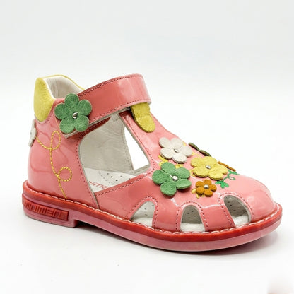 Children’s pink closed‑toe orthopedic sandals with Velcro straps, flower accents, arch and ankle support, featuring Thomas heels by Minimen.