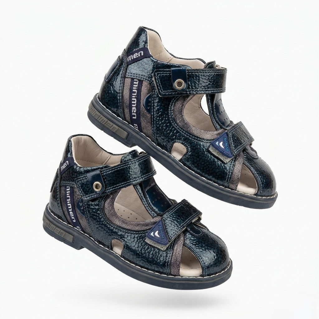 Children’s orthopedic sandal by Minimen in navy, highlighting its arch support, ankle support, and Thomas heel construction in a studio-style image.