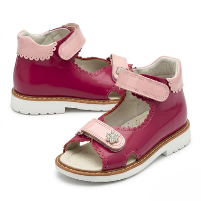 Mid-top fuchsia leather girls sandals with extended Thomas heel, padded pink collar, and sturdy white traction sole