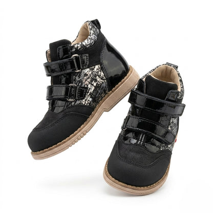Black orthopedic shoe for kids with arch and ankle support, Thomas heel, Velcro closures, and textured mixed‑material design by Ortho Shoes.