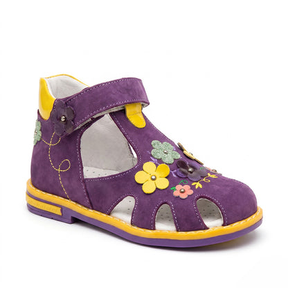 Children’s purple orthopedic sandal with Velcro strap, arch support, ankle stability, Thomas heel, and colourful flower details by Minimen.