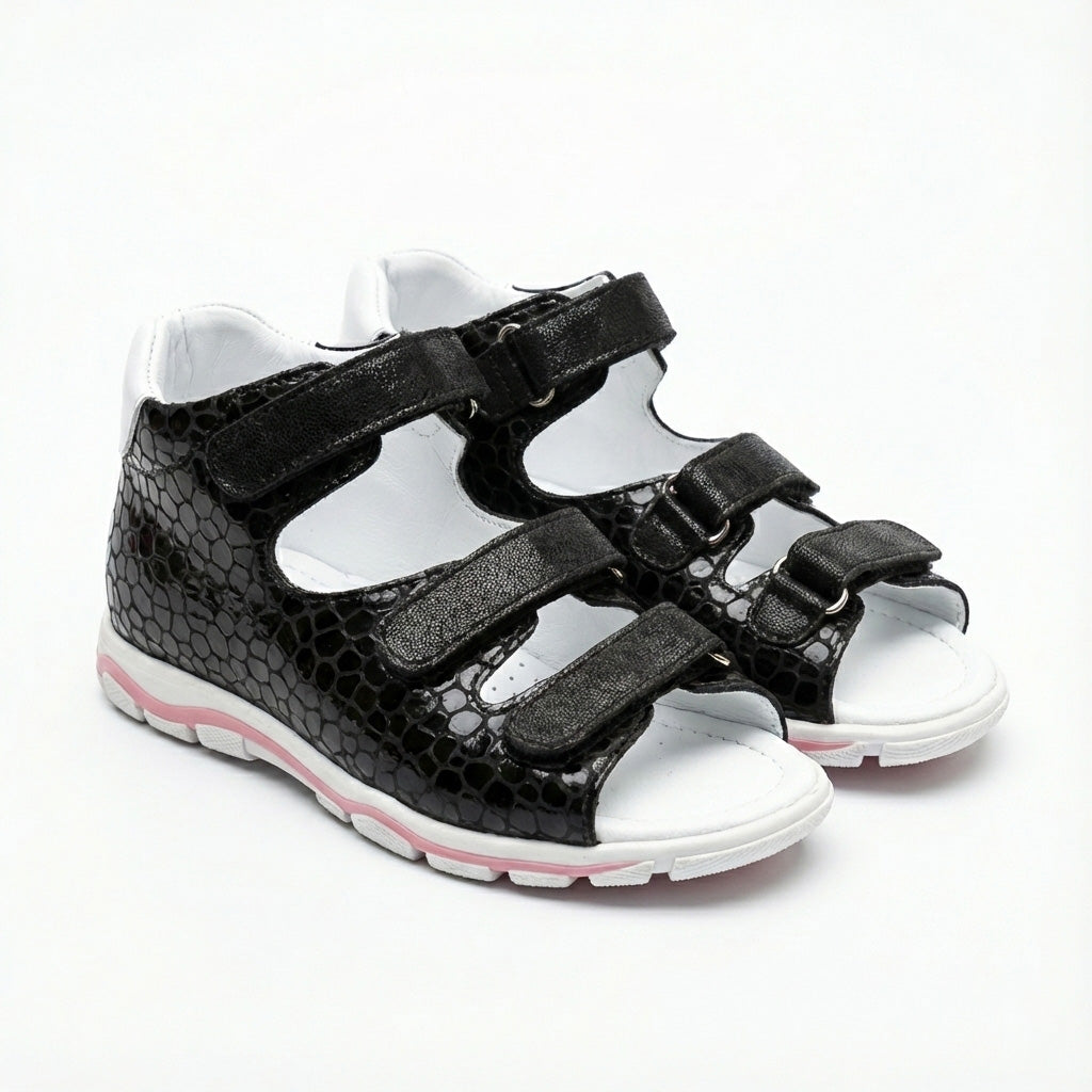Supportive black orthopedic sandals with three Velcro straps, open sides and arch support.