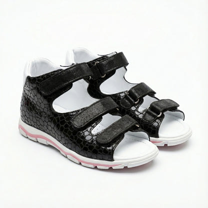 Supportive black orthopedic sandals with three Velcro straps, open sides and arch support.