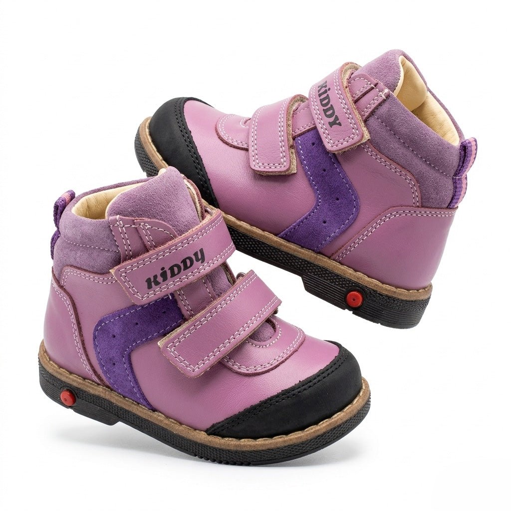 Kids’ purple orthopedic boots with Velcro straps, arch support, ankle stability, Thomas heels, and cushioned tan soles.