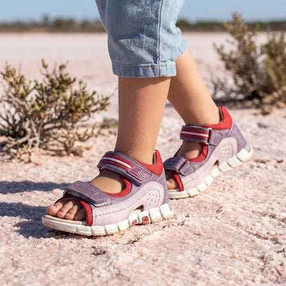 Red and purple leather orthopaedic sandals for girls featuring dual Velcro straps and firm arch support.
