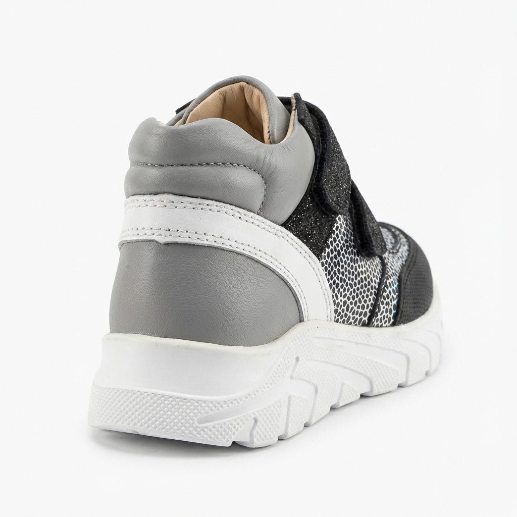 Kids’ mid-top orthopedic sneakers with Velcro straps, arch and ankle support, chunky sole, and silver-black design by Ortho Shoes.