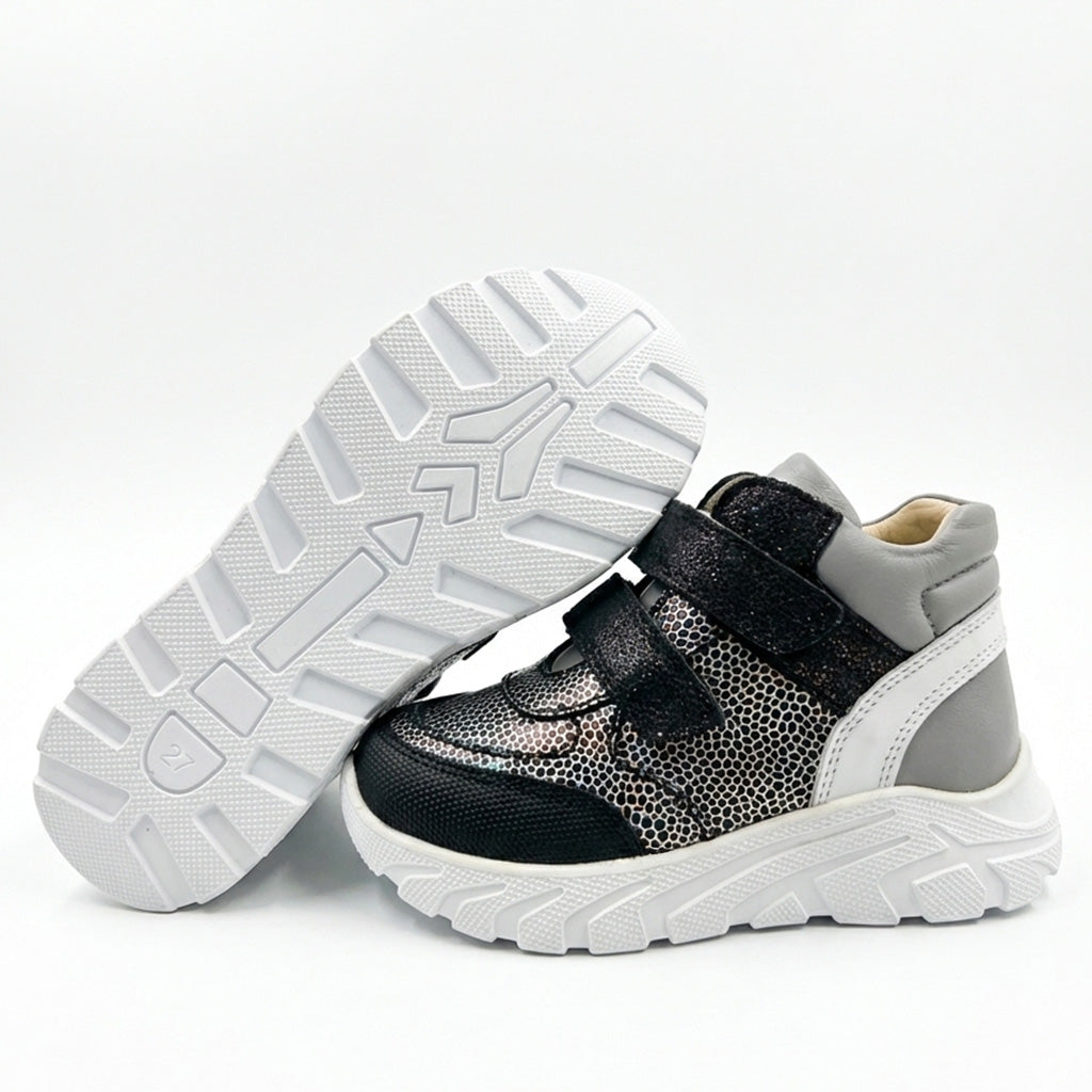 Kids’ mid-top orthopedic sneakers with Velcro straps, arch and ankle support, chunky sole, and silver-black design by Ortho Shoes.