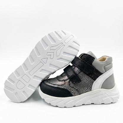 Kids’ mid-top orthopedic sneakers with Velcro straps, arch and ankle support, chunky sole, and silver-black design by Ortho Shoes.