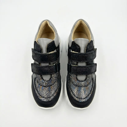 Kids’ mid-top orthopedic sneakers with Velcro straps, arch and ankle support, chunky sole, and silver-black design by Ortho Shoes.