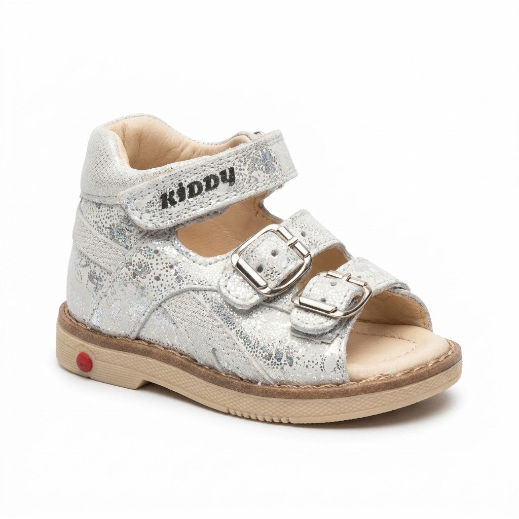 Shimmering silver leather mid-top kids sandals with two buckle straps, top Velcro strap, and sturdy beige sole.