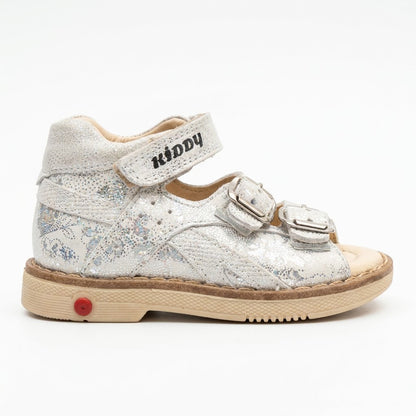 Shimmering silver leather mid-top kids sandals with two buckle straps, top Velcro strap, and sturdy beige sole.