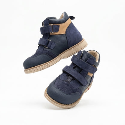 Oliver boys orthopaedic boots showing the extended Thomas heel and structured cream sole by Ortho Shoes.