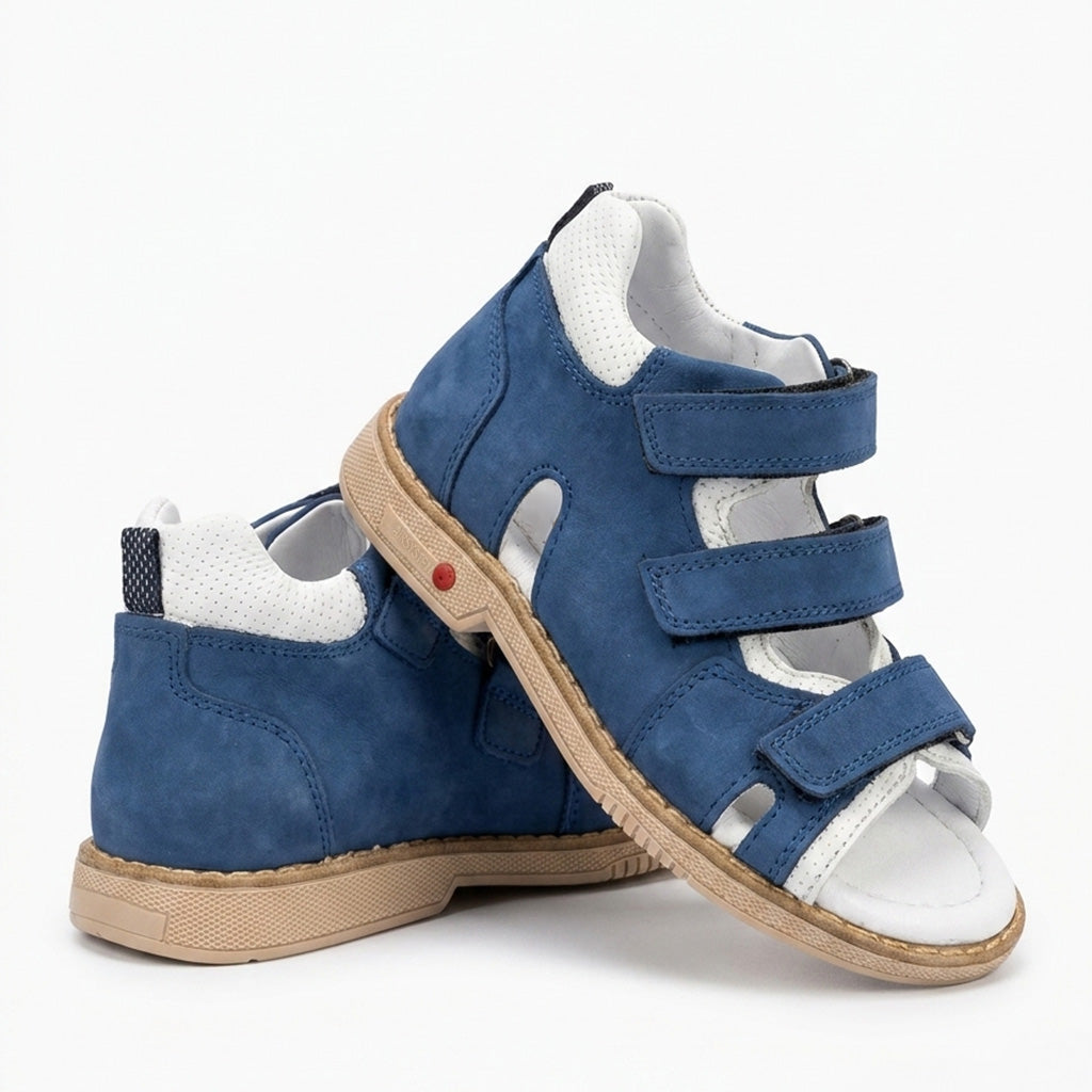 Kids orthopaedic sandals in matte blue nubuck and white leather with three adjustable Velcro straps and a tan sole.