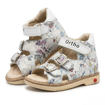 Kids orthopaedic sandals in floral white leather with three adjustable buckle straps and a supportive cream sole.