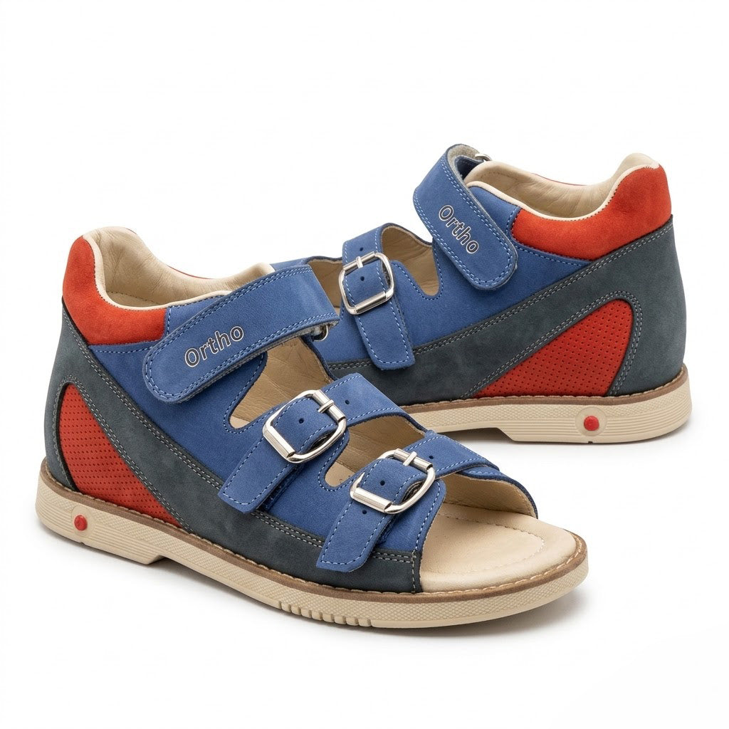 Side view of boys blue and red mid-top sandals showing secure Velcro ankle strap and buckle details.