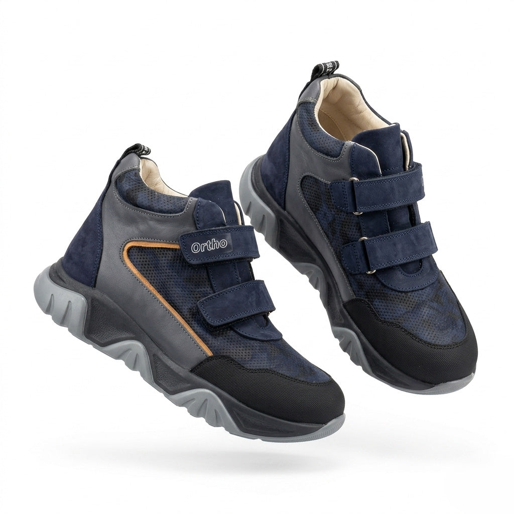 Kids orthopedic boots in dark blue with Velcro straps, rugged grey sole, arch and ankle support, and Ortho branding.