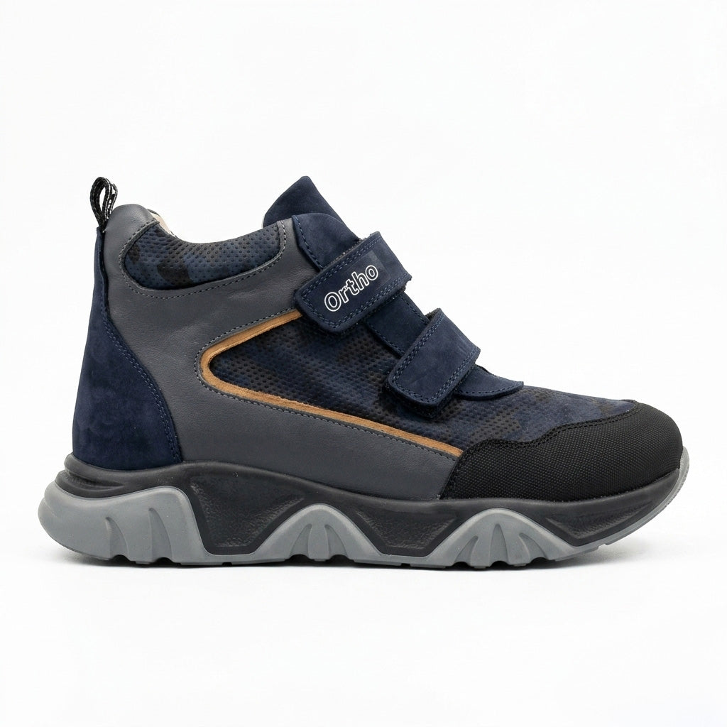 Kids orthopedic boots in dark blue with Velcro straps, rugged grey sole, arch and ankle support, and Ortho branding.