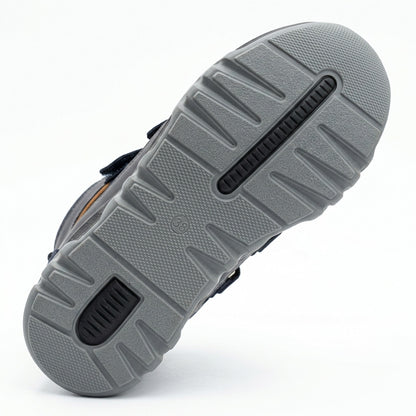 Kids orthopedic boots in dark blue with Velcro straps, rugged grey sole, arch and ankle support, and Ortho branding.