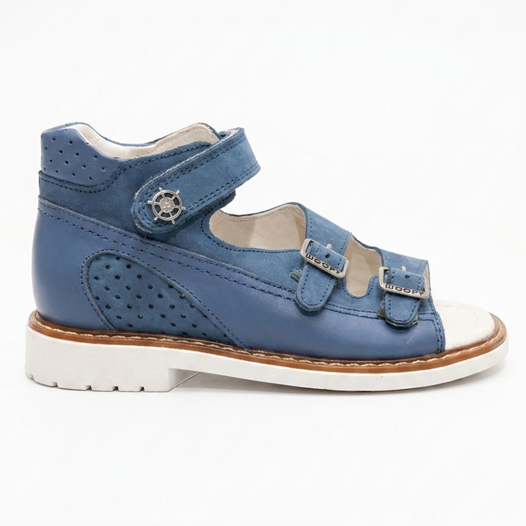 Blue mid-top orthopaedic sandals with a sturdy white sole, Thomas heel, perforated leather, and ship helm charm.