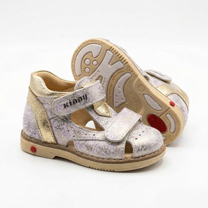 Kids’ silver Kiddy sandal with gold accents, dual Velcro straps, cracked‑texture upper, cushioned arch support, ankle support and Thomas heels.