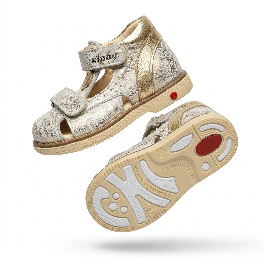 Kids’ silver Kiddy sandal with gold accents, dual Velcro straps, cracked‑texture upper, cushioned arch support, ankle support and Thomas heels.