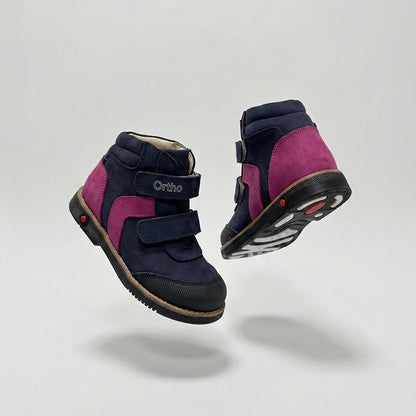 Girls’ orthopedic shoe in navy and pink with Velcro straps, arch support, Thomas heel, and Ortho Shoes branding.