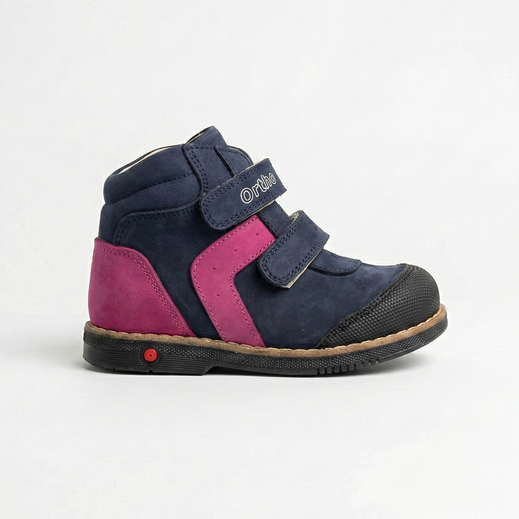 Girls’ orthopedic shoe in navy and pink with Velcro straps, arch support, Thomas heel, and Ortho Shoes branding.