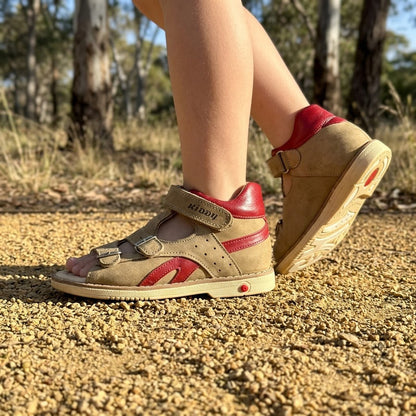 Boys beige nubuck orthopaedic open-toe sandals with deep red accents, mid-top ankle strap, and arch support