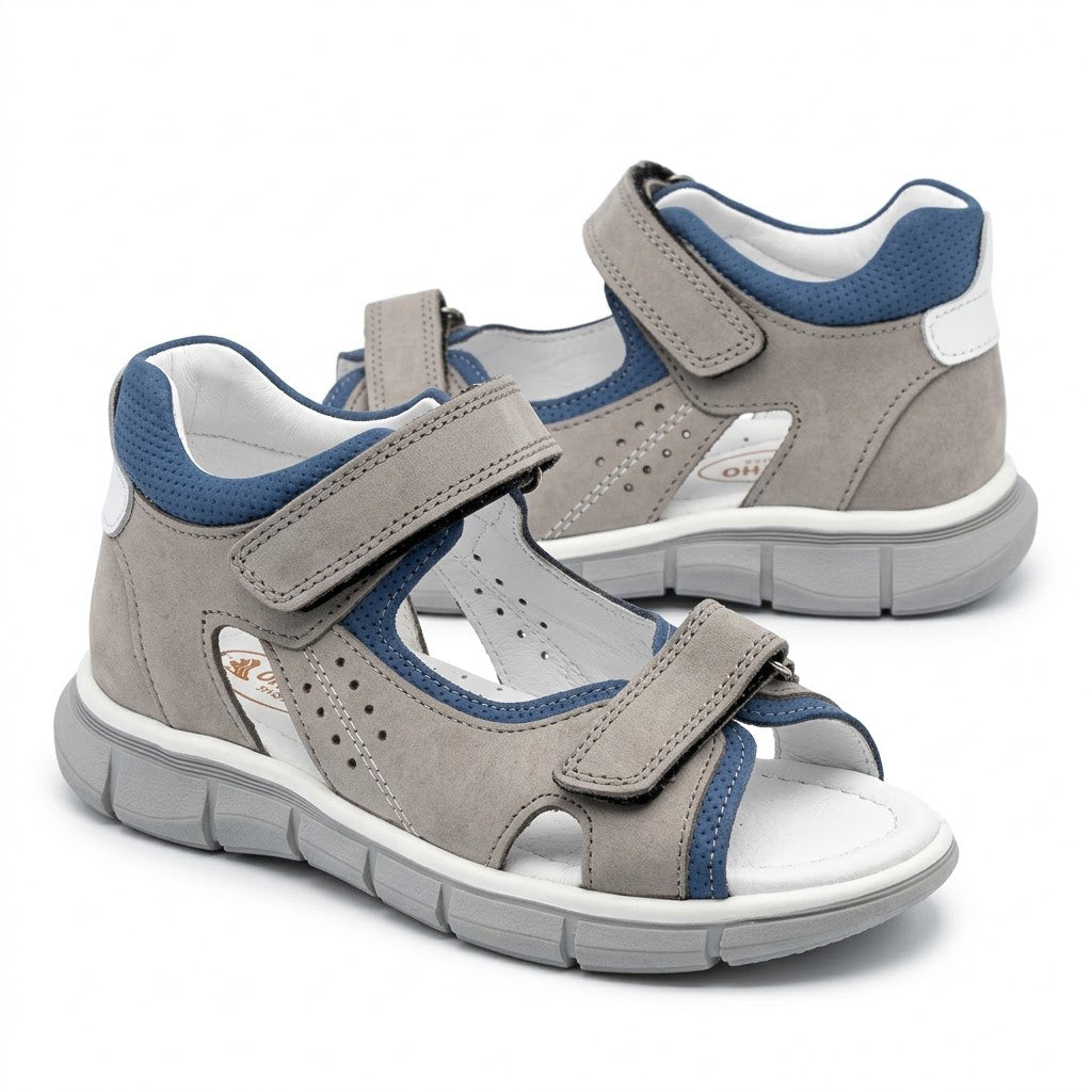 Grooved grey traction outsole on boys low-top orthopaedic sandals showing arch and heel guidance contours