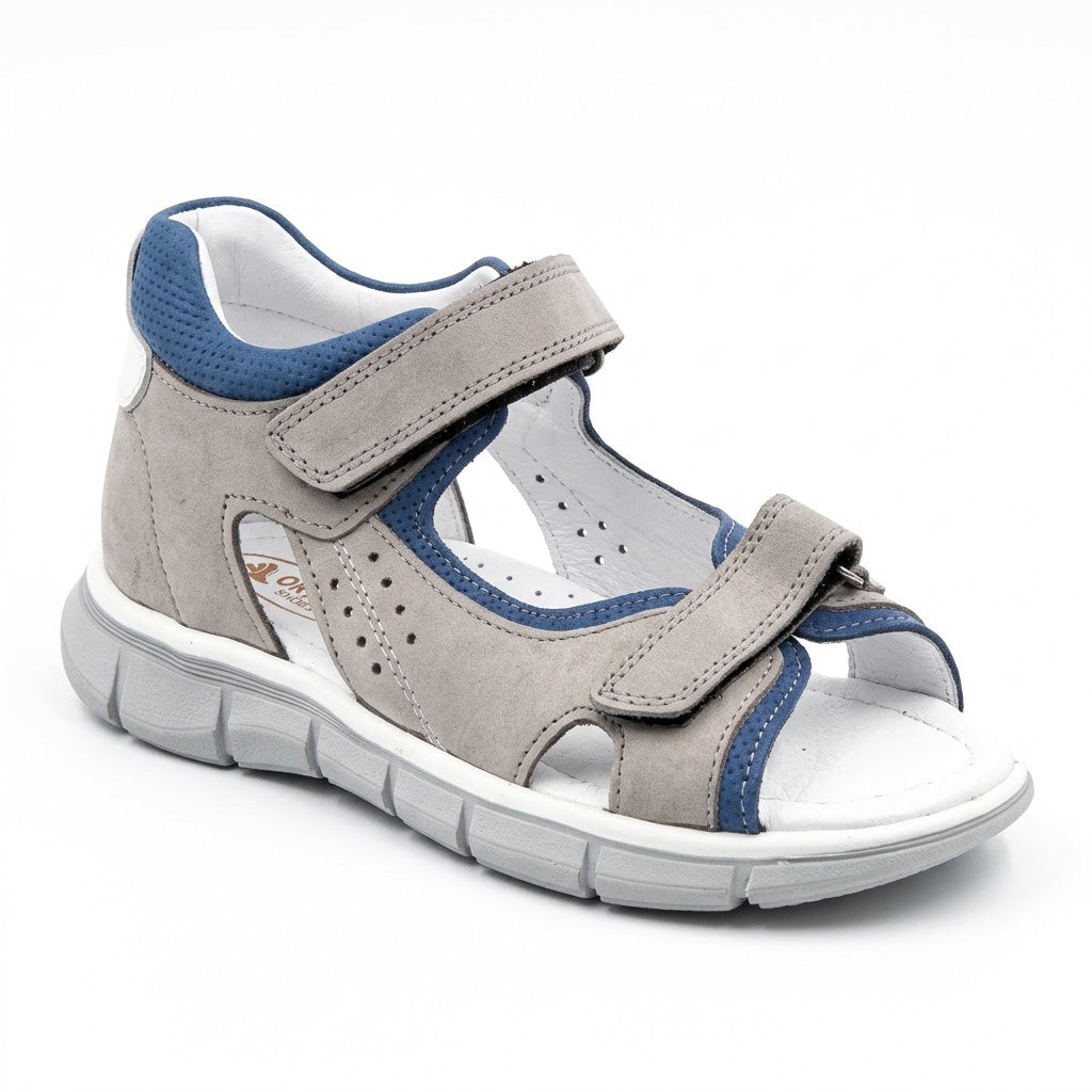 Grooved grey traction outsole on boys low-top orthopaedic sandals showing arch and heel guidance contours