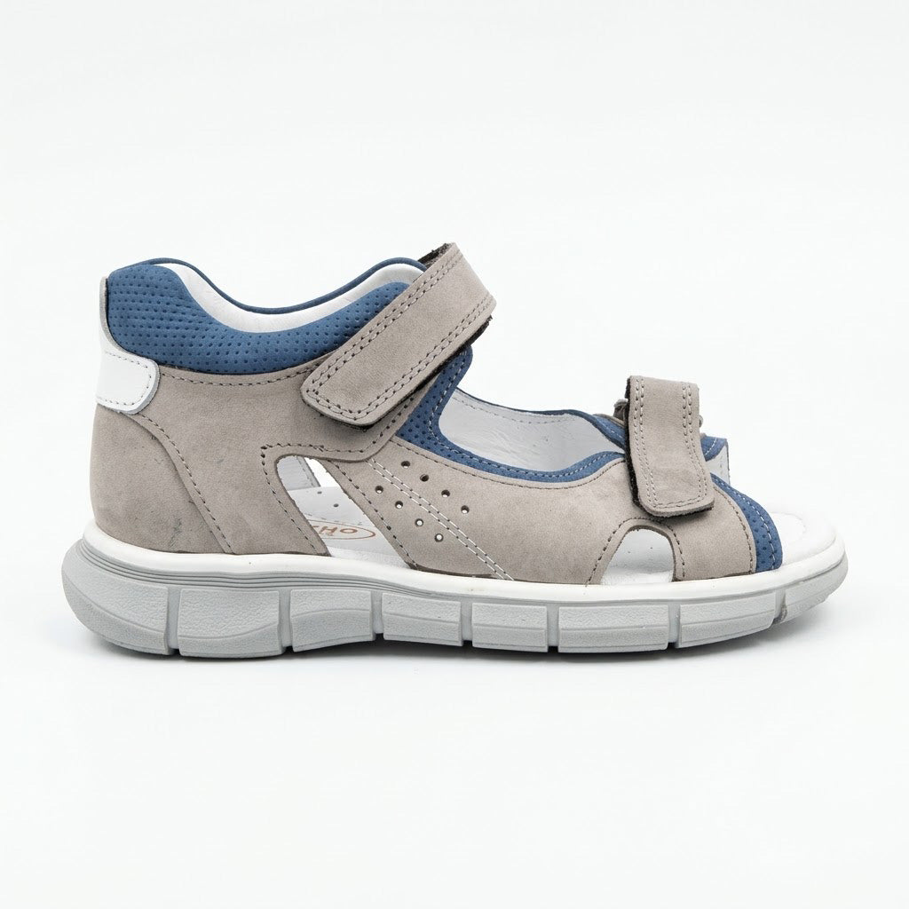 Grooved grey traction outsole on boys low-top orthopaedic sandals showing arch and heel guidance contours